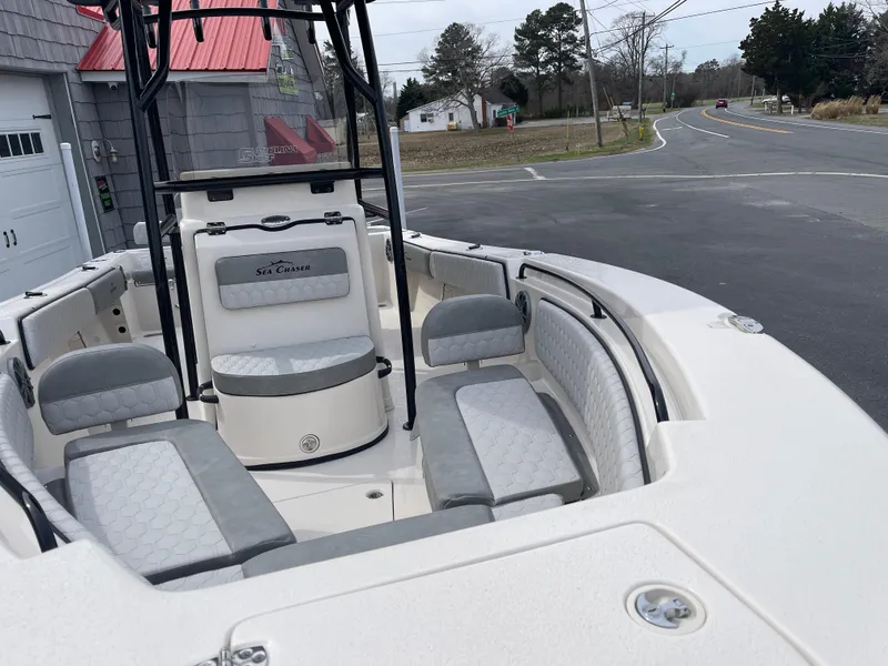 Slide: The Image of 2025 Sea Chaser 22 HFC boat with Suzuki outboard motor on trailer, American flag displayed. - 8