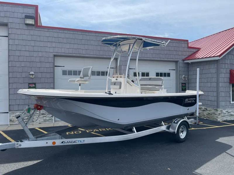 Slide: The Image of 2025 Carolina Skiff 19 LS boat on trailer, displayed outdoors under clear blue sky. - 1