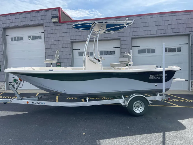 Slide: The Image of 2025 Carolina Skiff 19 LS boat on trailer, displayed outdoors under clear blue sky. - 2