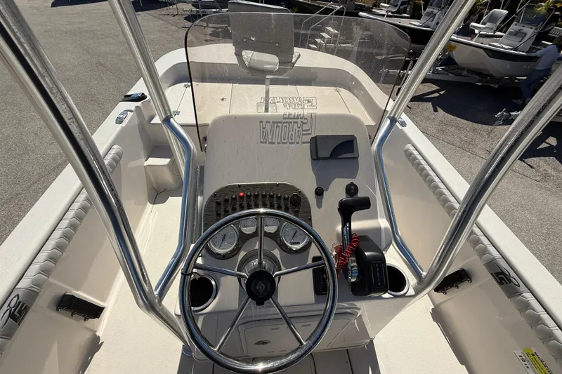 Slide: The Image of 2025 Carolina Skiff 19 LS boat console with steering wheel and controls. - 22