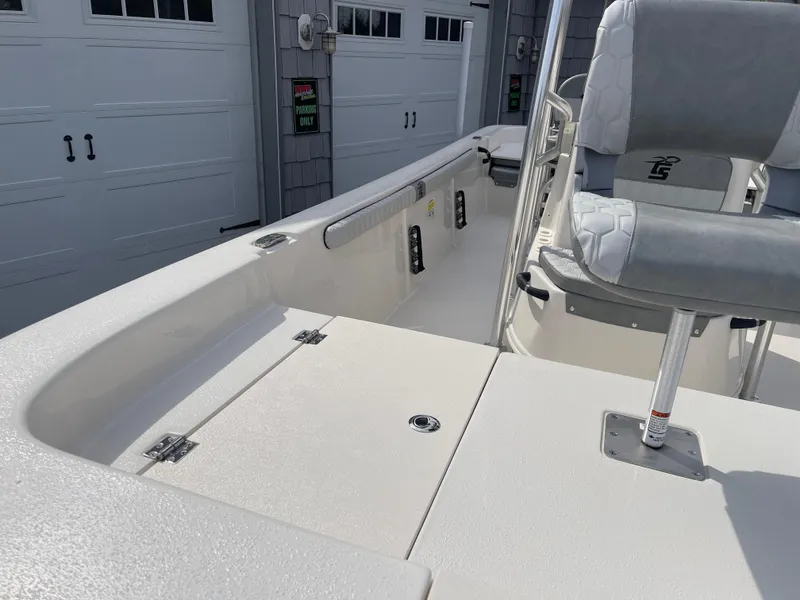 Slide: The Image of 2025 Carolina Skiff 19 LS boat, rear view, in a sunny outdoor showroom. - 7