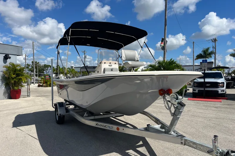 Slide: The Image of 2025 Carolina Skiff 19 LS boat on trailer under blue sky. - 1