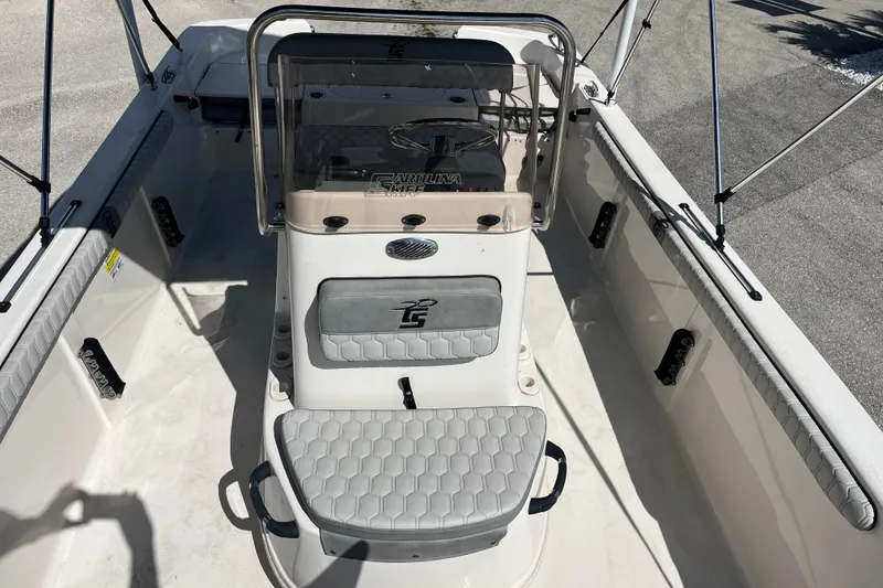 Slide: The Image of 2025 Carolina Skiff 19 LS boat interior with seating and console, viewed from above. - 7