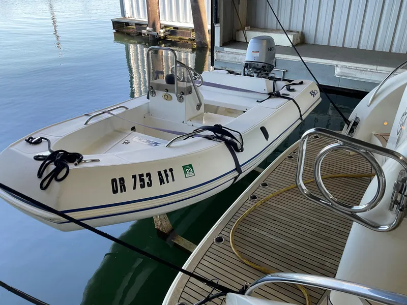 Slide: The Image of Small white boat docked beside Ocean Alexander 54V yacht, 2007 model, in a marina. - 10