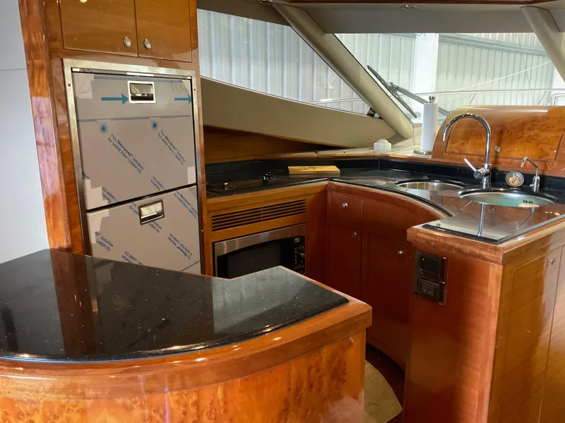 Slide: The Image of Luxurious kitchen interior of 2007 Ocean Alexander 54V yacht with wood cabinetry and modern appliances. - 14