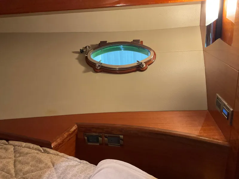 Slide: The Image of Interior of 2007 Ocean Alexander 54V yacht with porthole and wooden finish. - 17