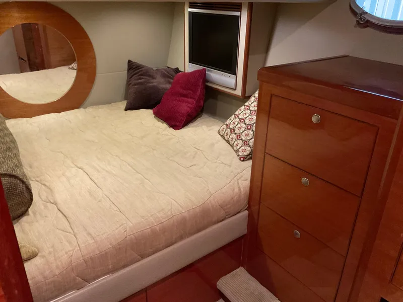 Slide: The Image of Cozy bedroom in 2007 Ocean Alexander 54V yacht with wooden cabinetry and plush bedding. - 20