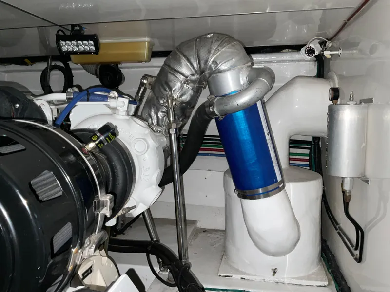 Slide: The Image of Engine room of 2007 Ocean Alexander 54V yacht, showcasing mechanical components and piping. - 27