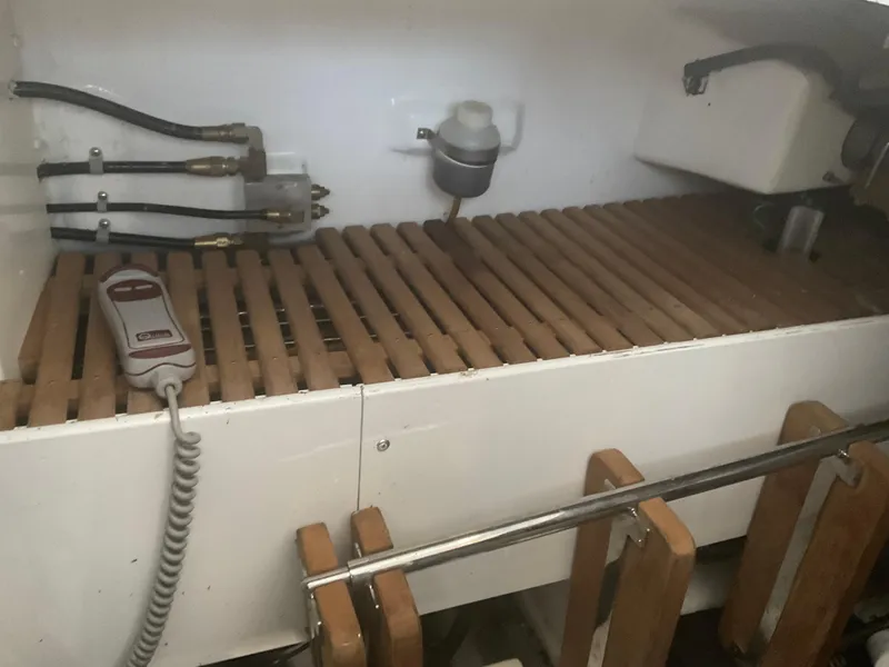 Slide: The Image of Engine room of 2007 Ocean Alexander 54V yacht with wooden slats and control panel. - 36