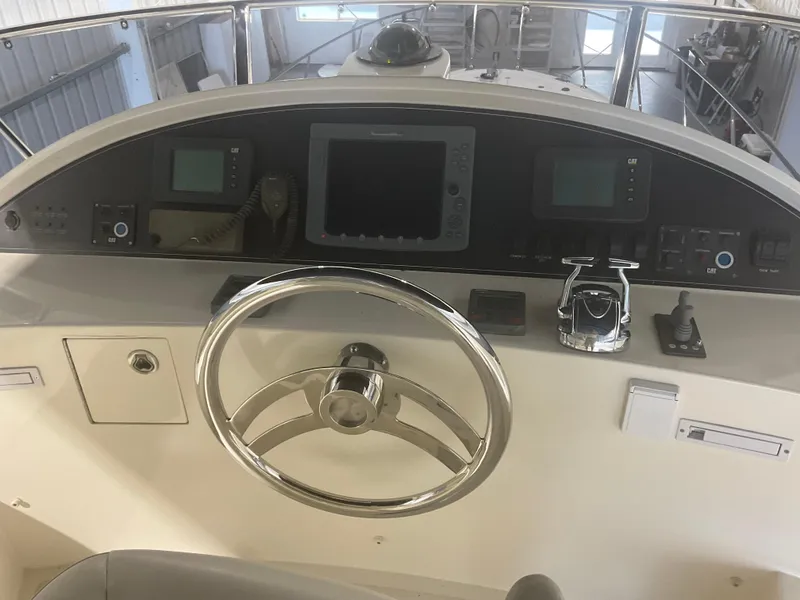 Slide: The Image of Helm of 2007 Ocean Alexander 54V yacht with steering wheel and navigation controls. - 38