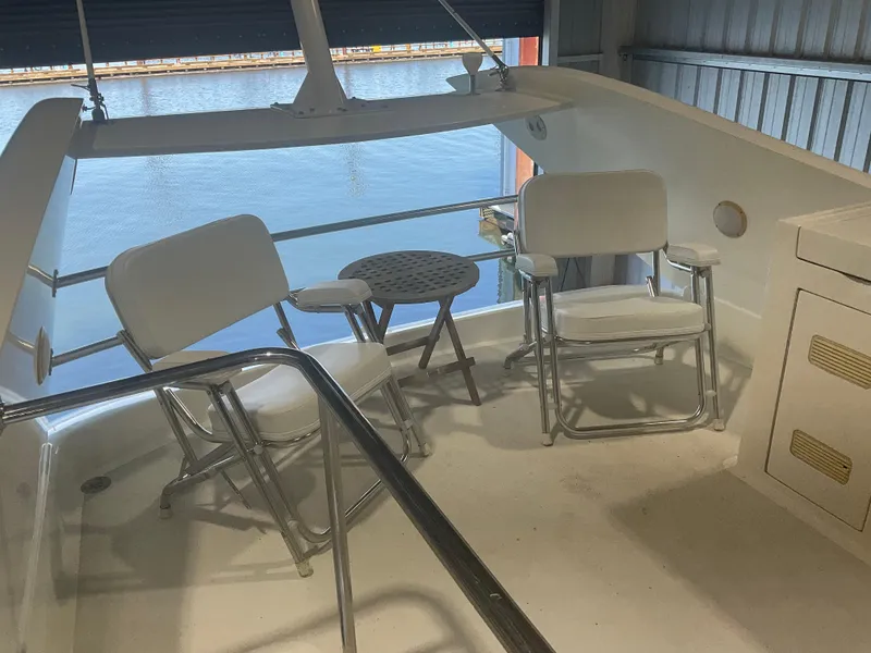 Slide: The Image of 2007 Ocean Alexander 54V yacht deck with chairs and table, overlooking water. - 39