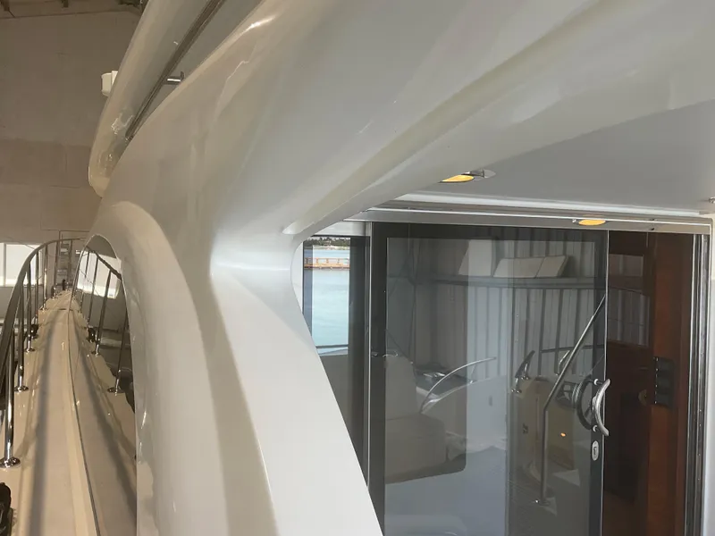 Slide: The Image of 2007 Ocean Alexander 54V yacht, sleek exterior design with glass doors and railing. - 40