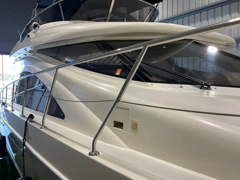 Slide: The Image of 2007 Ocean Alexander 54V yacht, sleek design, docked indoors, side view. - 6