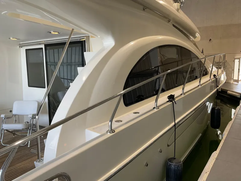 Slide: The Image of 2007 Ocean Alexander 54V yacht docked indoors, showcasing sleek design and spacious deck area. - 7