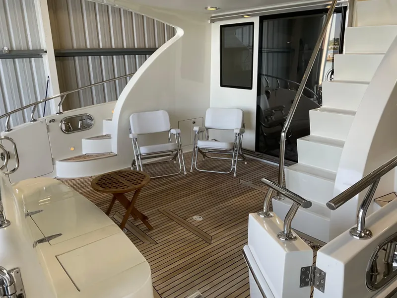 Slide: The Image of Luxurious 2007 Ocean Alexander 54V yacht deck with seating and elegant wooden flooring. - 8