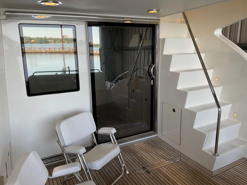Slide: The Image of Luxury yacht interior with seating, stairs, and glass door; Ocean Alexander 54V, 2007 model. - 9