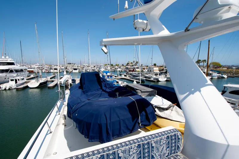 Slide: The Image of 1988 Knight & Carver Motoryacht docked in a marina, surrounded by other boats. - 15