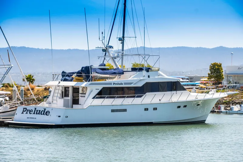 Slide: The Image of 1988 Knight & Carver Motoryacht docked in a serene marina setting. - 2