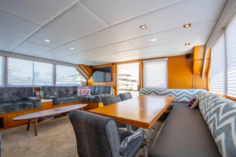Slide: The Image of Luxurious 1988 Knight & Carver motoryacht interior with elegant seating and dining area. - 21