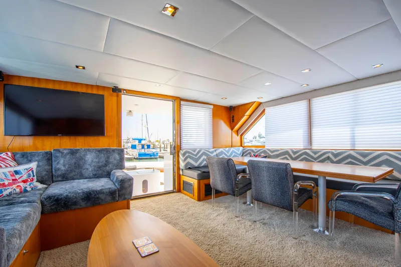 Slide: The Image of Luxurious 1988 Knight & Carver motoryacht interior with plush seating and dining area. - 23