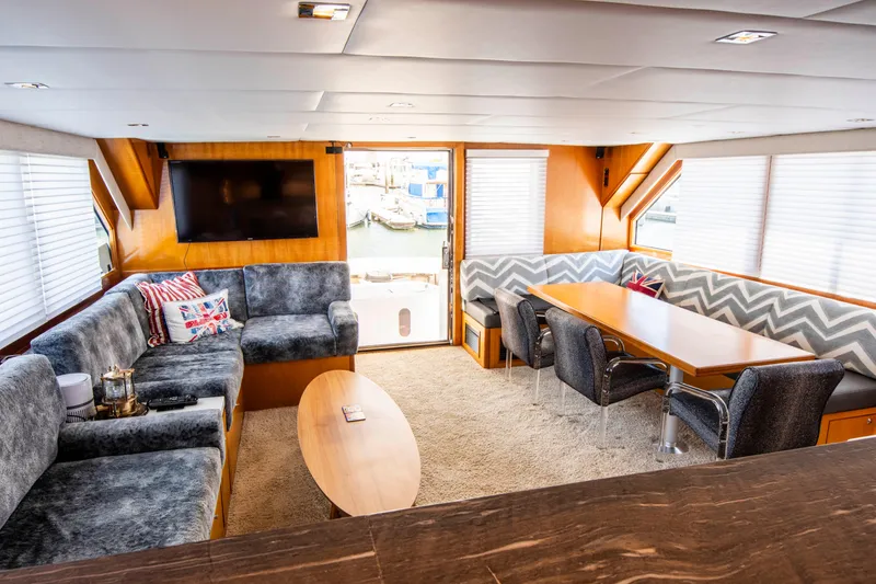Slide: The Image of Luxurious 1988 Knight & Carver motoryacht interior with plush seating and dining area. - 25