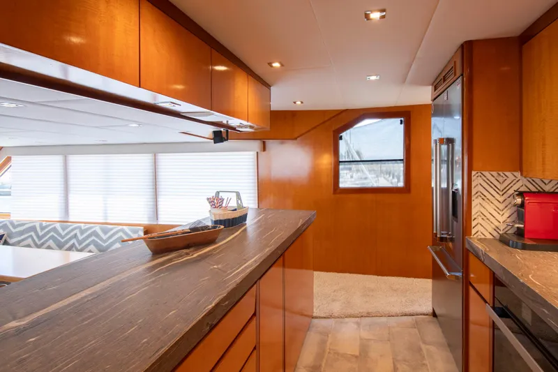 Slide: The Image of Luxurious 1988 Knight & Carver motoryacht interior with modern kitchen and elegant wood finishes. - 28