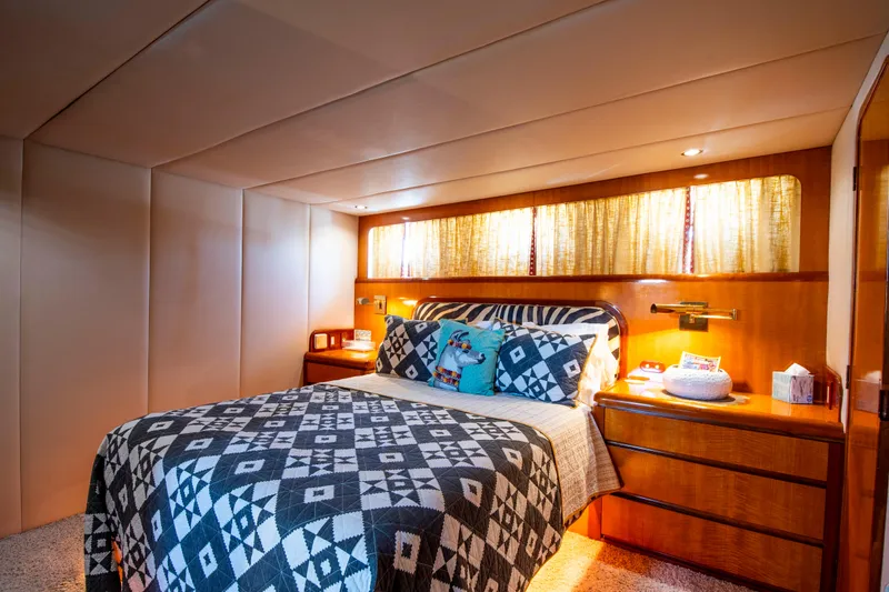 Slide: The Image of Luxurious 1988 Knight & Carver motoryacht bedroom with patterned bedding and warm lighting. - 30