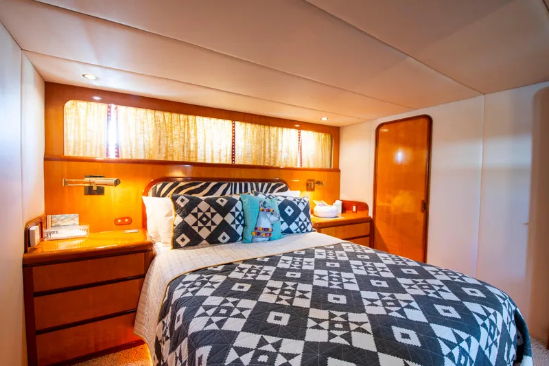 Slide: The Image of Luxurious 1988 Knight & Carver motoryacht bedroom with patterned bedding and warm wood accents. - 31