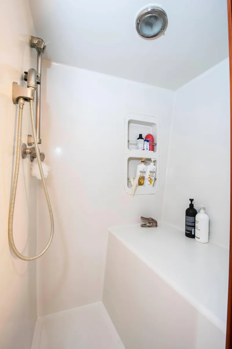 Slide: The Image of Shower area in 1988 Knight & Carver motoryacht with built-in shelves and handheld showerhead. - 34