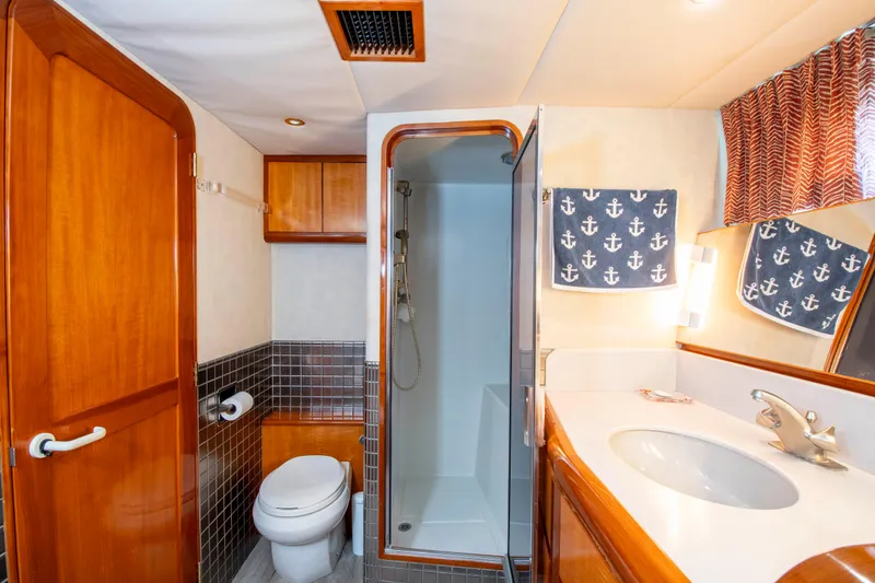 Slide: The Image of Luxurious 1988 Knight & Carver motoryacht bathroom with shower, sink, and nautical-themed decor. - 35