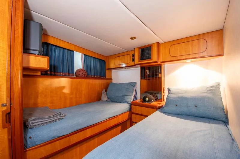 Slide: The Image of Twin cabin in 1988 Knight & Carver motoryacht with wooden interior and blue bedding. - 37