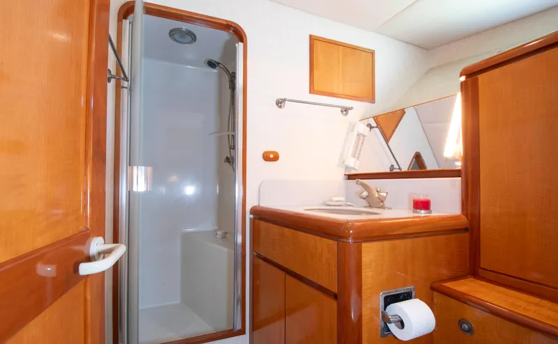 Slide: The Image of 1988 Knight & Carver Motoryacht bathroom with shower, wooden cabinetry, and sink. - 38