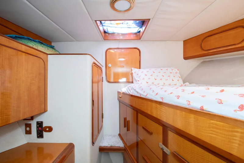 Slide: The Image of 1988 Knight & Carver Motoryacht cabin with wooden interior and cozy bedding. - 39