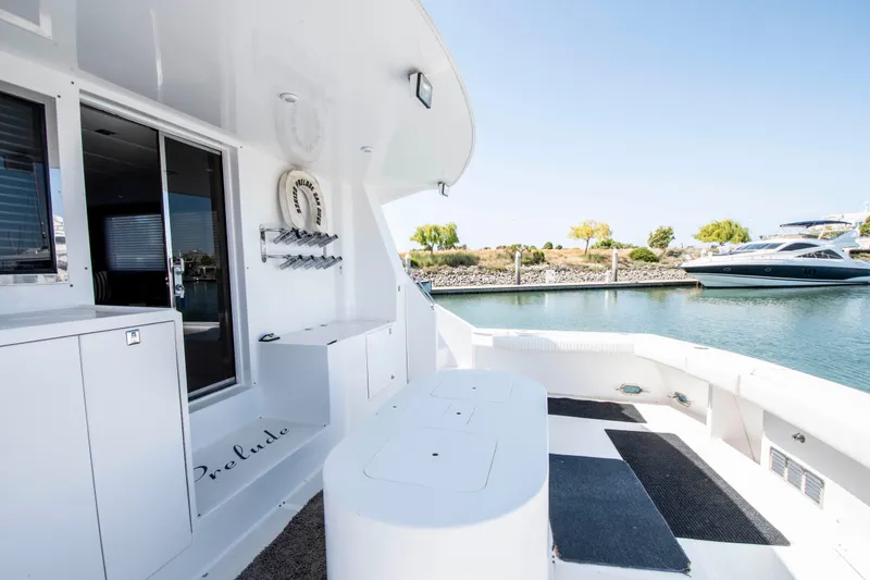 Slide: The Image of 1988 Knight & Carver Motoryacht deck, featuring sleek design and waterfront view. - 4