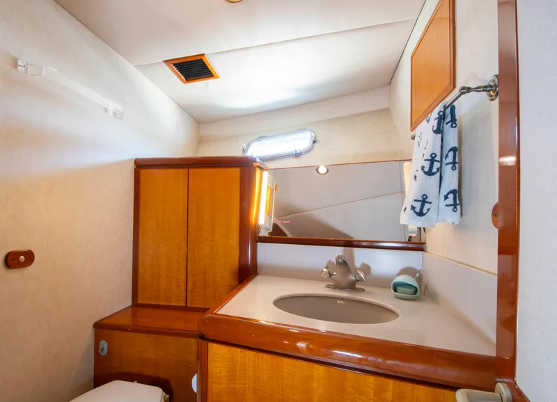 Slide: The Image of Luxurious 1988 Knight & Carver motoryacht bathroom with wooden cabinetry and nautical-themed decor. - 42
