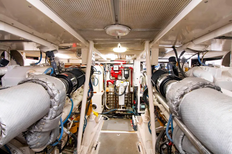 Slide: The Image of Engine room of a 1988 Knight & Carver Motoryacht, showcasing machinery and equipment. - 43
