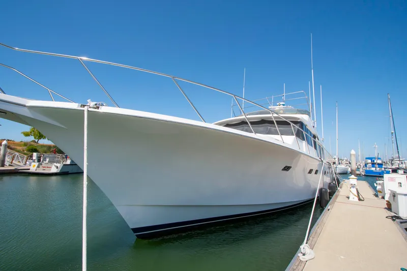 Slide: The Image of 1988 Knight & Carver Motoryacht docked in a marina under clear blue skies. - 54