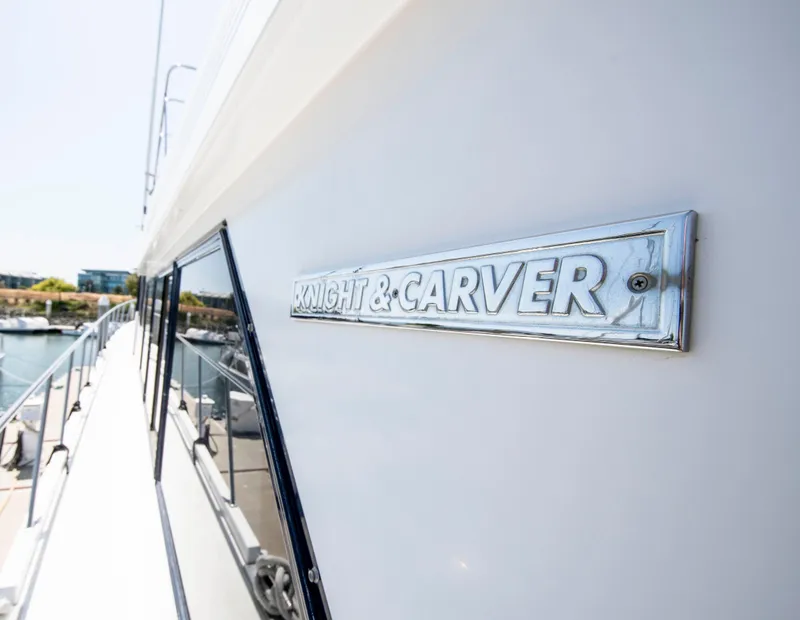 Slide: The Image of 1988 Knight & Carver Motoryacht with logo, docked by the water. - 55