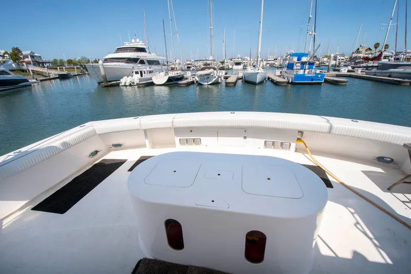 Slide: The Image of 1988 Knight & Carver Motoryacht docked at a marina, featuring spacious deck and seating area. - 6