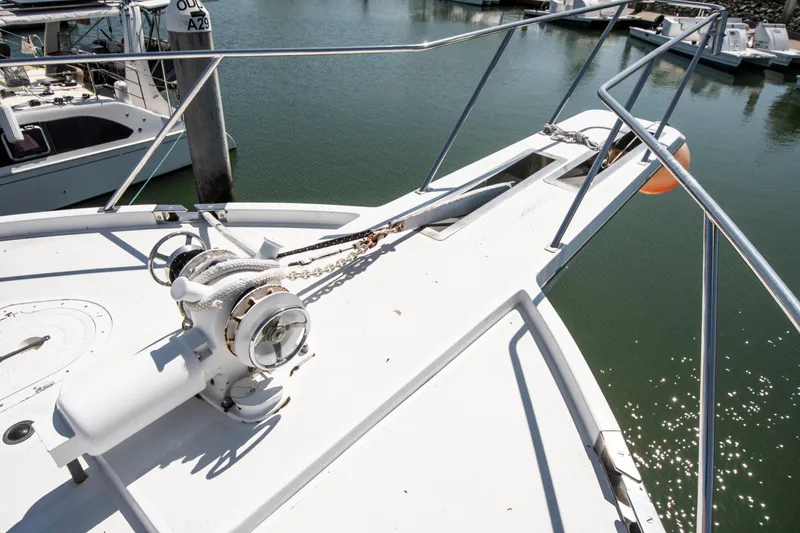 Slide: The Image of 1988 Knight & Carver Motoryacht bow with anchor chain and railing in marina. - 7