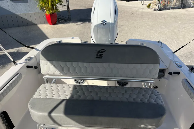 Slide: The Image of 2025 Carolina Skiff 21 LS boat interior with gray seating and Suzuki outboard motor. - 14