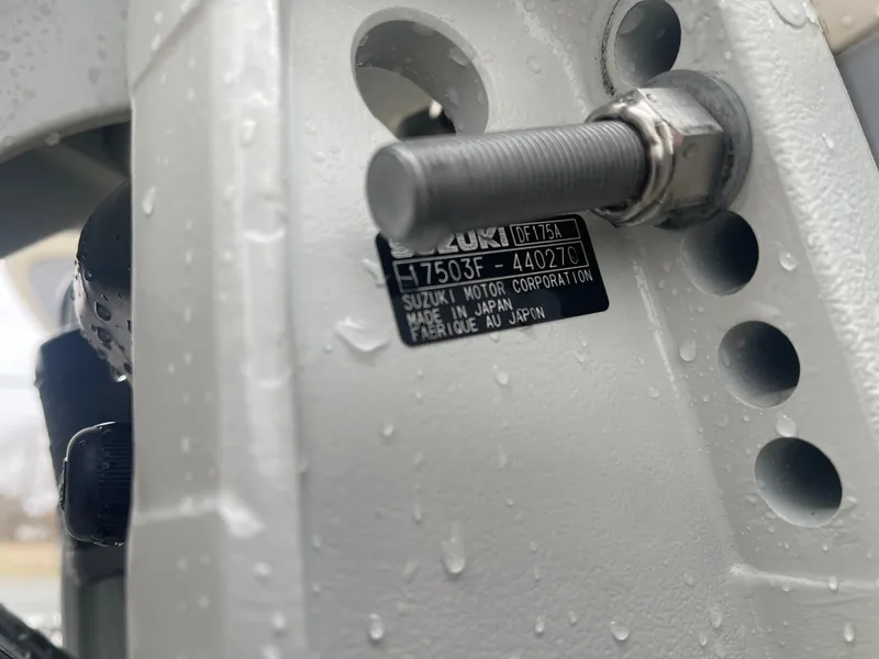 Slide: The Image of Close-up of a Suzuki motor part on a 2025 Carolina Skiff 21 LS boat. - 15