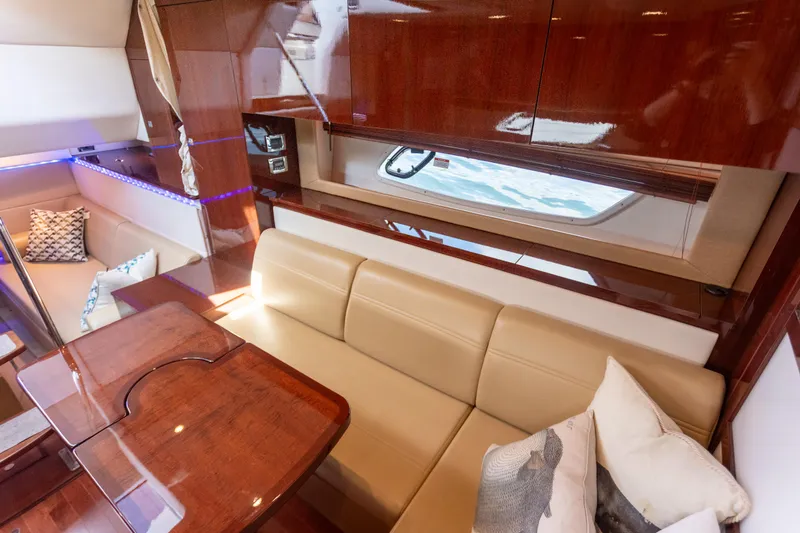 Slide: The Image of Luxurious interior of 2011 Sea Ray 450 Sundancer yacht with leather seating and wooden finishes. - 31