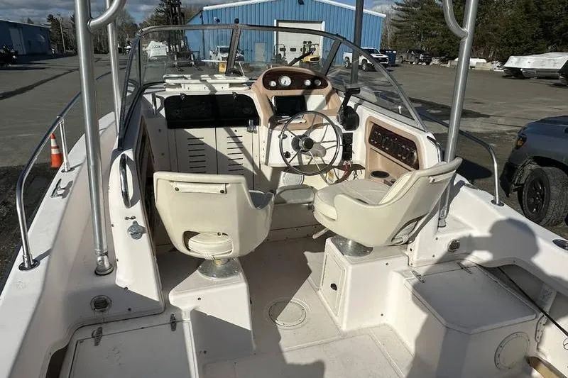 Slide: The Image of 1997 Grady-White Adventure 208 boat interior with steering wheel and seating. - 2