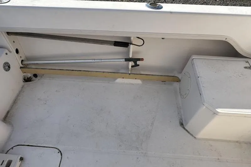 Slide: The Image of Interior view of a 1997 Grady-White Adventure 208 boat, showing storage and seating area. - 3