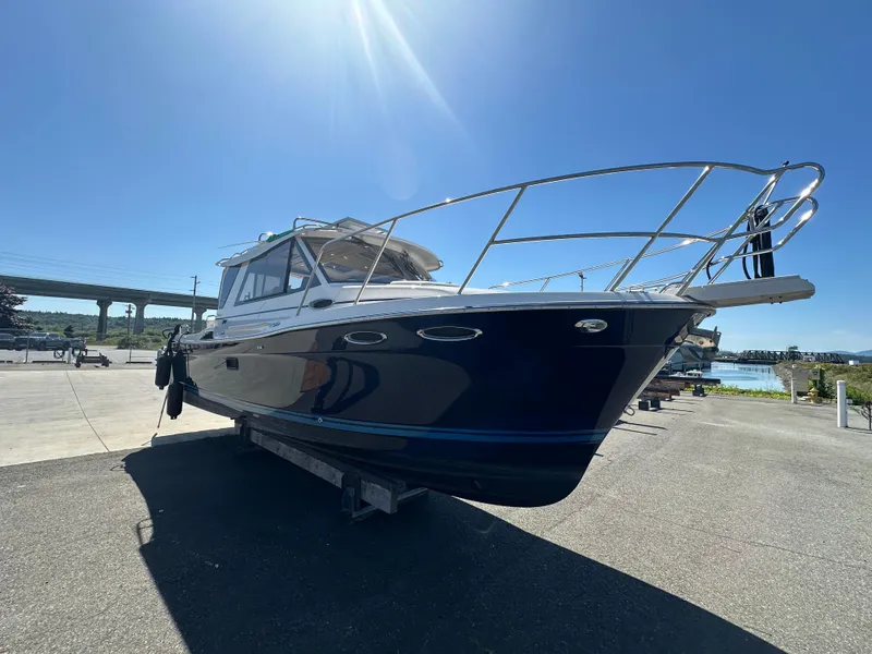 Slide: The Image of 2019 Cutwater C-28 boat on trailer under clear blue sky. - 2