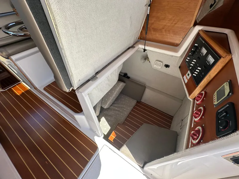 Slide: The Image of 2019 Cutwater C-28 cabin interior with control panel and wooden flooring. - 27