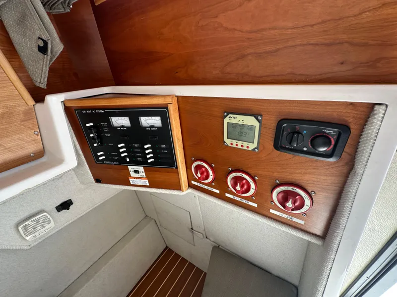 Slide: The Image of Electrical control panel inside 2019 Cutwater C-28 boat, featuring switches and meters. - 28