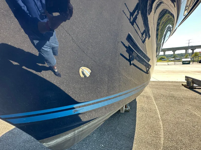 Slide: The Image of 2019 Cutwater C-28 boat hull with reflection, parked on asphalt. - 35