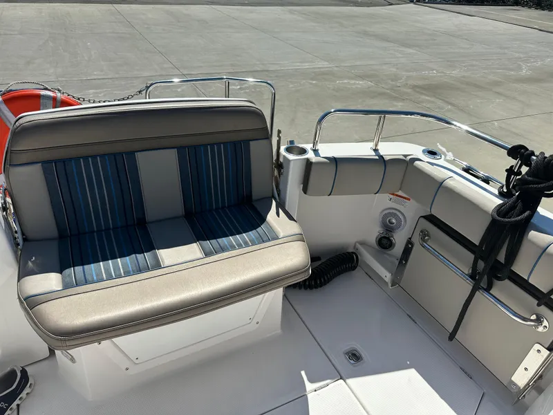 Slide: The Image of 2019 Cutwater C-28 boat interior with striped seating and stainless steel railings. - 4